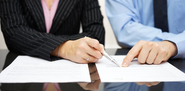 Man and woman pointing at part of a contract