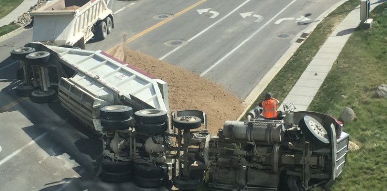 Truck on its side across a road