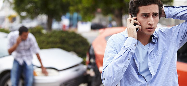 Man on phone after car accident