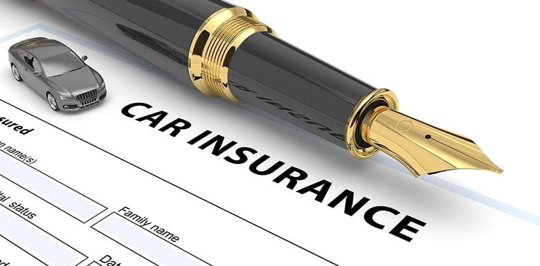 Car insurance form with a pen and toy car