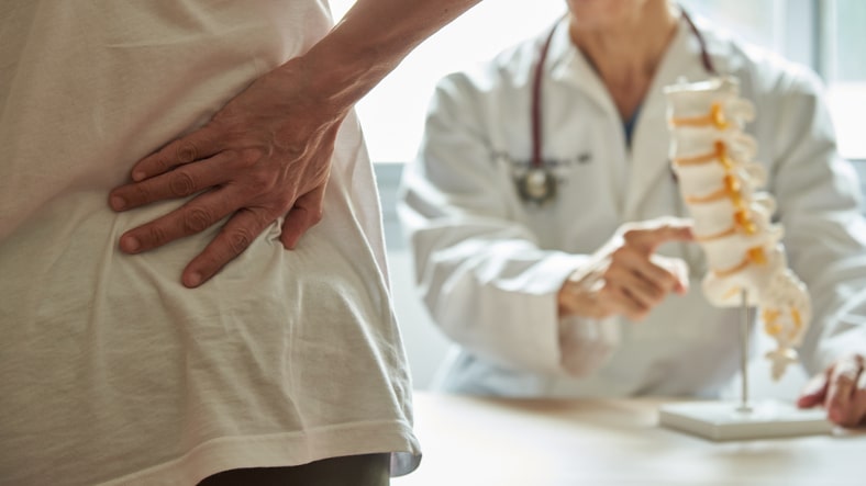 Doctor pointing to spine model