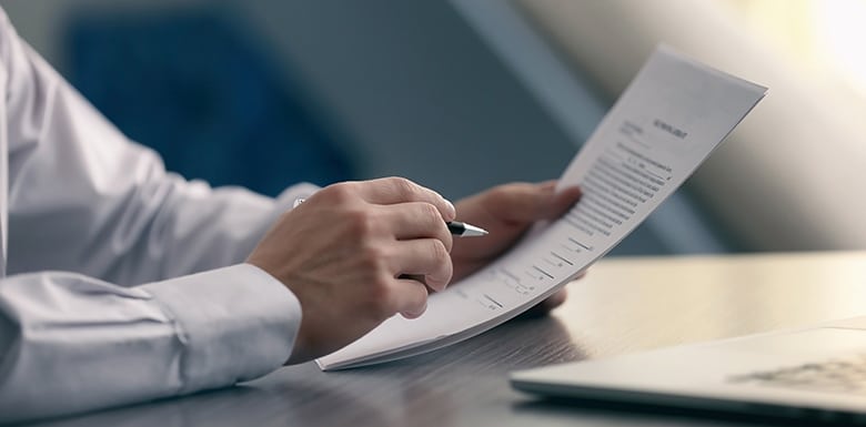 man inspecting contract with pen