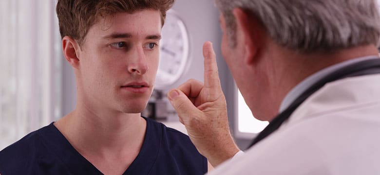 A doctor running eye tests on a man