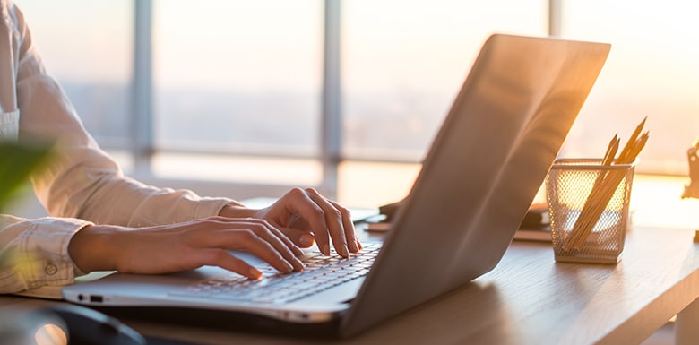Female attorney typing on laptop at her desk