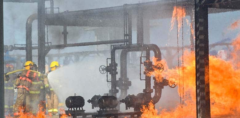 Firefighters fighting fire at oil collection site